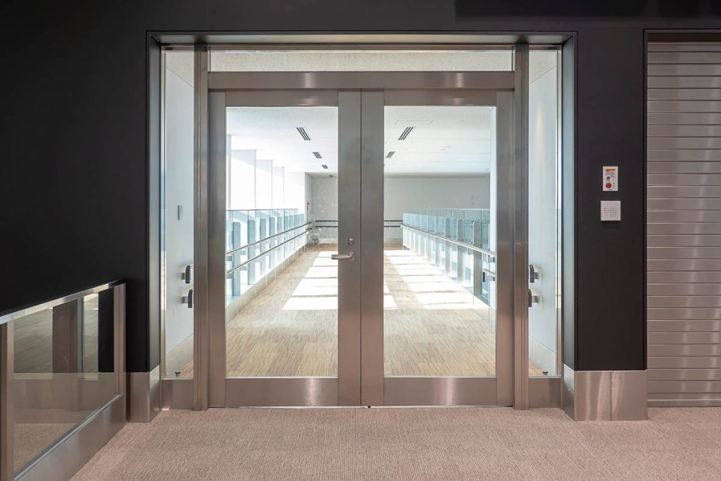 Automatic transparent door, Metallic frame with glass on corridor of modern building, image for background